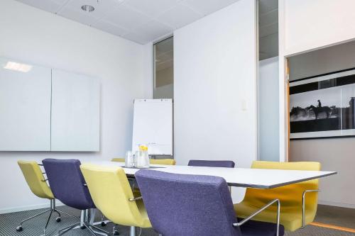 a meeting room with a table and chairs at Best Western Plus Park City Malmö in Malmö