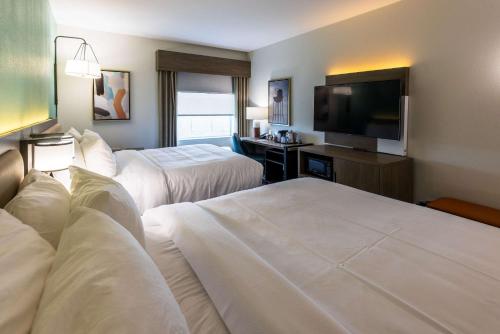 a hotel room with two beds and a flat screen tv at Comfort Inn & Suites New Iberia - Avery Island in New Iberia