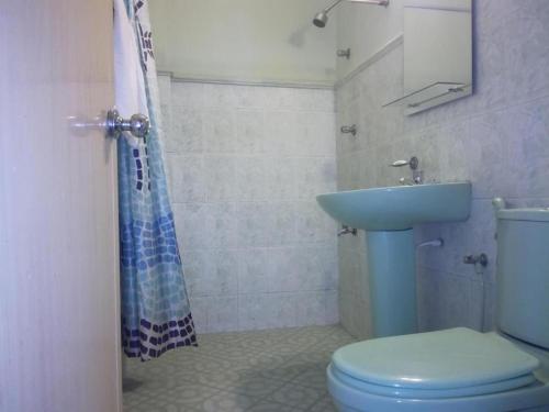 a bathroom with a blue toilet and a sink at Victory Inn Monaragala in Monaragala