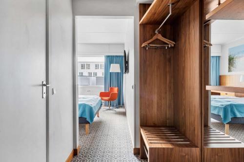 a hotel room with a bed and a room with a room at Best Western Plus Park Globetrotter Copenhagen Airport in Copenhagen