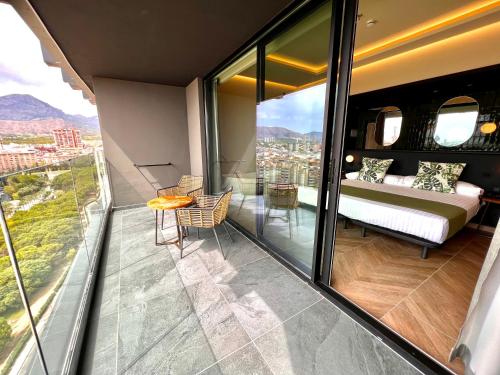 a bedroom with a bed on a balcony at Hotel Primavera Park in Benidorm