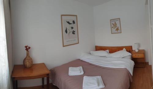 a bedroom with a bed with two towels on it at Azuga Apartament Super View & Ski in Azuga