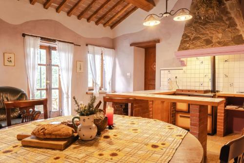 a kitchen with a table with a counter top at Reggioli- Appartamento Erborista in Gaiole in Chianti