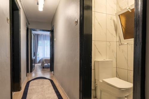 a bathroom with a toilet and a hallway at Cosy & Cental 3BR Apt. In Besiktas in Istanbul