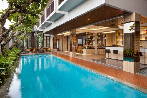 a swimming pool in the middle of a building at Kinaralana Hotel Yogyakarta in Yogyakarta