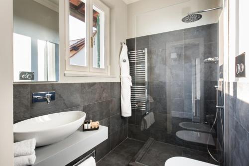 a bathroom with a white sink and a shower at Tornabuoni Suites Collection Residenza D'Epoca in Florence