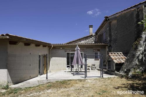 a house with a fence in front of it at Ferme en pleine campagne in Castelsagrat