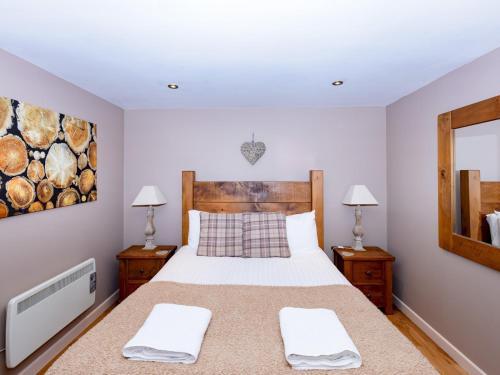 a bedroom with a large bed with two night stands at Pass the Keys Stylish Garden cottage in Wells, Somerset in Wells