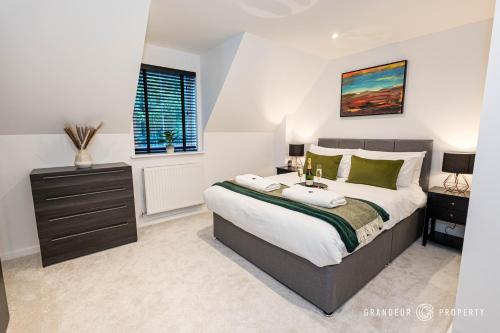 a bedroom with a large bed and a window at Elegant townhouse, Westbourne, Sleeps 8, Parking - The Hideaway in Bournemouth