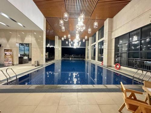 a large swimming pool in a large building at New Modern Luxury Suite Apartment At The Heart of Vientiane in Vientiane