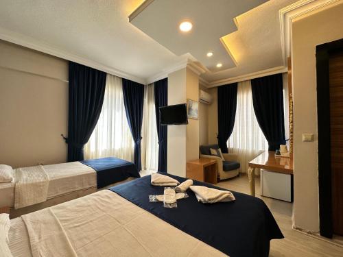 a hotel room with two beds with towels on them at Serenity suites Hotel in Antalya