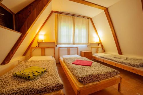 a room with two beds and a window at Enchanted Forest Chalet in Tatranska Strba