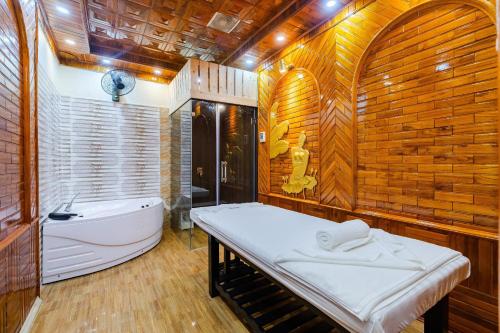 uma casa de banho com uma cama e uma banheira em Noi Bai The King Hotel em Sóc Sơn