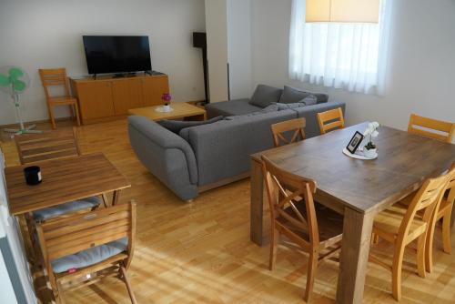 a living room with a table and a couch at APARTMA My HILL 5 in Maribor