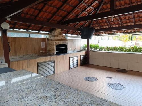 a patio with an outdoor kitchen with a pizza oven at Apartamento Barra Villa d Italia HIR 32 in Rio de Janeiro