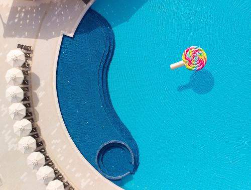 a candy lollipop in the water in a pool at Elexus Hotel Resort & Spa & Casino in Kérynia