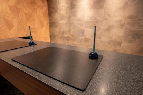 a counter top with two microphones on top of it at ピンポンホテル&キャビン pin pon hotel & cabin in Shunan