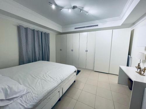 a white bedroom with a bed and a sink at lovely one bedroom self entry in Jeddah