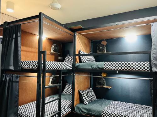 a bunk bed room with four bunk beds in it at Regalia Spritz Empire Hostel in Kuala Lumpur