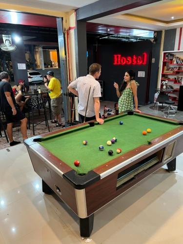 a group of people standing around a pool table at Hangover Aonang in Ao Nang Beach