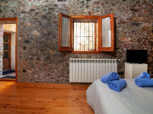 two beds in a room with a stone wall at Holiday Home Sant Joan by Interhome in Calonge