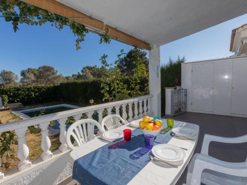 a table with a bowl of fruit on a balcony at Holiday Home Blanca by Interhome in Miami Platja