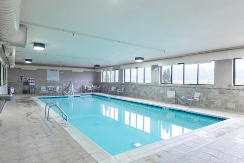 a large swimming pool with blue water in a building at Hampton Inn & Suites Radcliff/Fort Knox in Radcliff