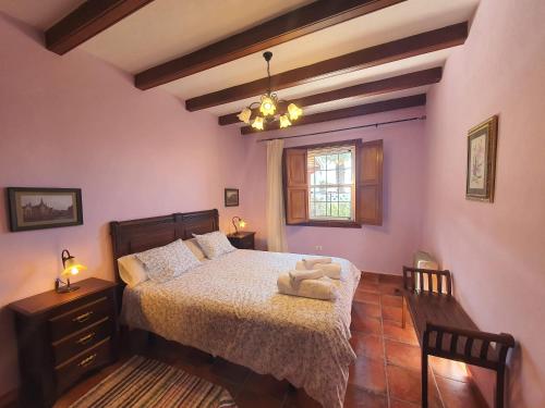 a bedroom with a bed and a window at Casa Bayon in El Paso