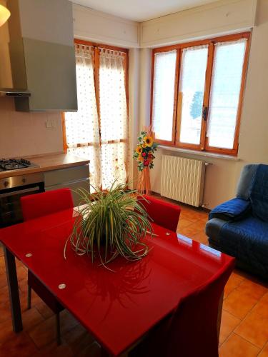 a living room with a red table and red chairs at RELAX HOUSE IN THE MOUNTAINS in Valdieri