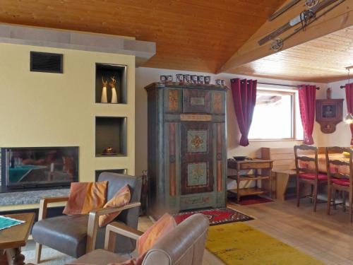 a living room with an old grandfather clock in a room at Chalet Mioche by Interhome in Wengen