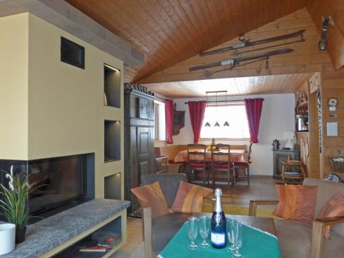 a living room with a table and a fireplace at Chalet Mioche by Interhome in Wengen