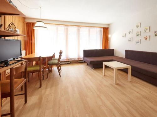 a living room with a couch and a table at Studio Combire 104 by Interhome in Les Collons