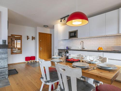 a kitchen and dining room with a wooden table and chairs at Apartment Brocard by Interhome in Val dʼIlliez