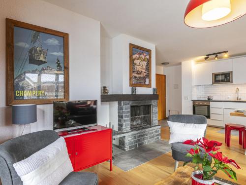 a living room with a tv and a fireplace at Apartment Brocard by Interhome in Val dʼIlliez
