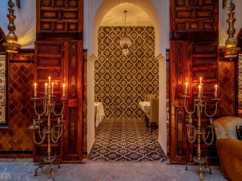 an entrance to a restaurant with an archway and a table at Riad Maialou & SPA in Marrakech