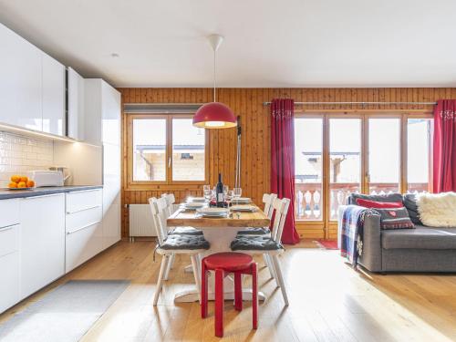 a kitchen and dining room with a table and a couch at Apartment Brocard by Interhome in Val dʼIlliez