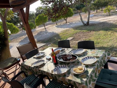a table with plates of food on a patio at Monte Velho - Country House in Canha