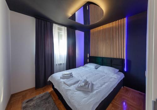a bedroom with a large bed with purple lighting at Luxury Residence in Belgrade