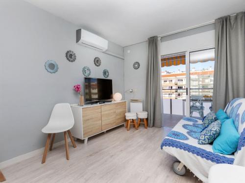 a bedroom with a bed and a tv in it at Apartment Lotus by Interhome in Blanes