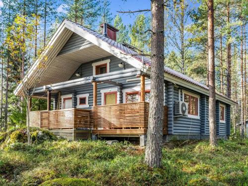 a small house in the woods with a tree at Holiday Home Ulpukka by Interhome in Savilahti
