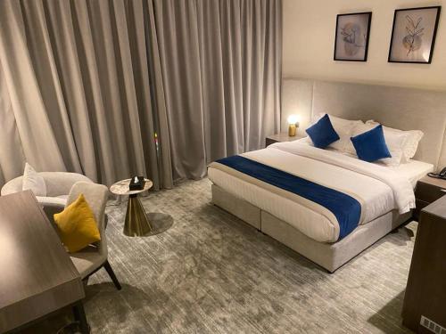 a hotel room with a bed and a chair at Savoye Hotel in Jeddah