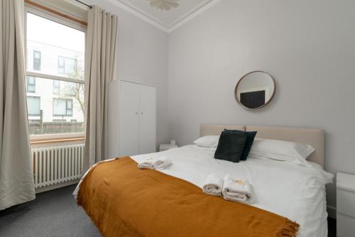 a bedroom with a bed with towels on it at Pass The Keys Main Door 3 Bed Apartment with Free Parking in Edinburgh