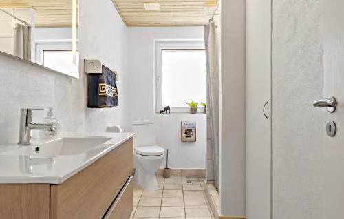 a white bathroom with a sink and a toilet at 3 Bedroom Pet Friendly Home In Ulfborg in Ulfborg