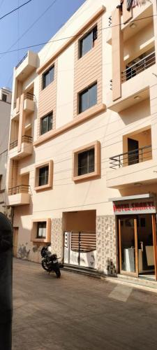 a building with a motorcycle parked in front of it at Hotel Shakti in Dwarka