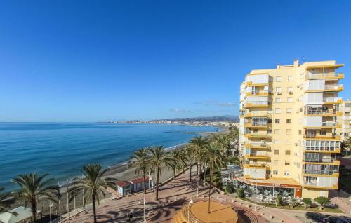 a view of a building and the ocean at Beach Front Apartment In Algarrobo-costa With Outdoor Swimming Pool in Algarrobo-Costa