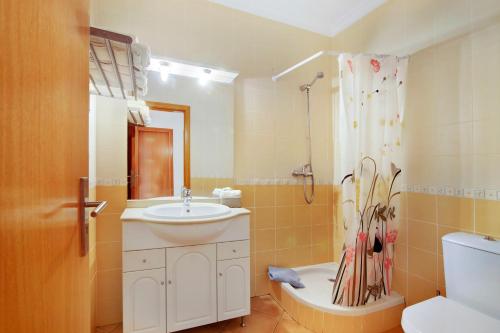 a bathroom with a sink and a toilet and a shower at Apartamento T3 Santa Luzia - H in Santa Luzia
