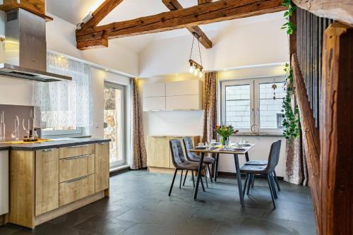 a kitchen and dining room with a table and chairs at Ameisberger - Landhaus in Mollmannsreith