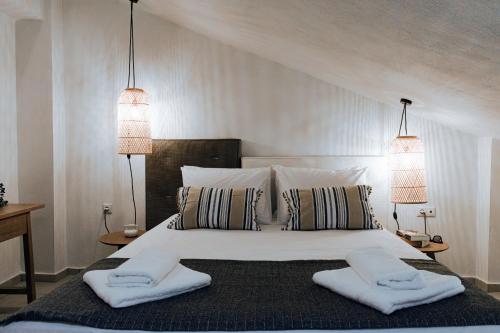 a bedroom with a large white bed with two pillows at Ona Boutique Apartments 2 in Hanioti