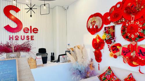 a store with red wreaths on the wall at Sele House in Hà Tiên