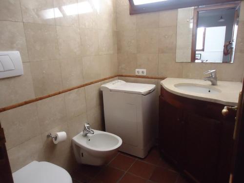a bathroom with a toilet and a sink at Playa Blanca Apartment, Marina Rubicon in Playa Blanca